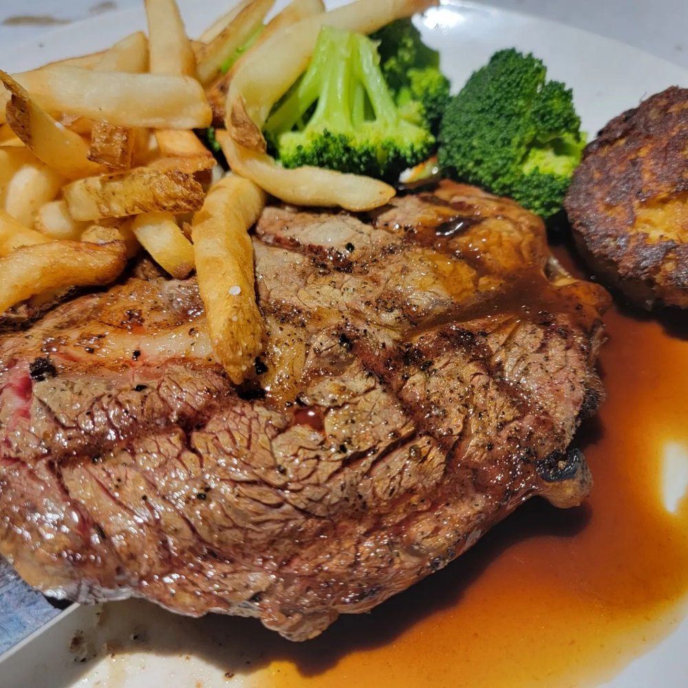 Trolley Steaks and Seafood - Ribeye steak, with a crab cake topper. - Steakhouses Near Me - Fort Wayne, Indiana Trolley Steaks and Seafood - Ribeye steak, with a crab cake topper. - Steakhouses Near Me - Fort Wayne, Indiana