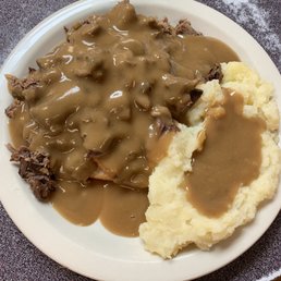 a plate of mashed potatoes and gravy