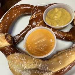 Pretzel with mustard and cheese dips Pretzel with mustard and cheese dips