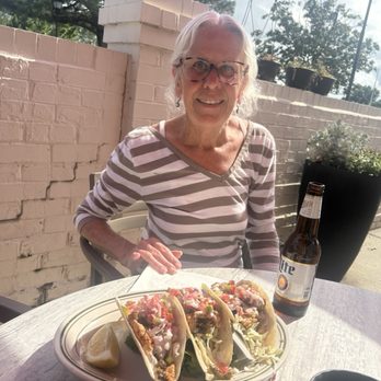 Kelly's Tavern - Marie presenting 3 blackened chicken fajita tacos on the patio seasoned with cilantro *chefs kiss* - Burgers Near Me - Virginia Beach, Virginia