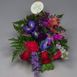 My Little Posy - Rich red roses layered with striking purple iris and lush ferns. A beautifully textured, jewel-toned masterpiece.