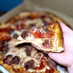 Central Pizza - Slice of Medium 14 pizza with Hamburg, pepperoni and onions - Greek style, showing crust thickness