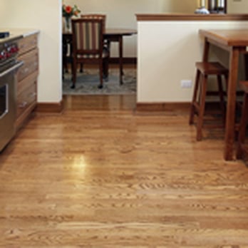 Unique Design - a kitchen with wood flooring and stainless steel appliances - Flooring Near Me - Topeka, Kansas