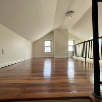 Grounded Electrical - an empty room with wood floors - Electricians Near Me