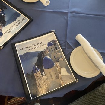 The Greek Taverna - a table setting with plates and napkins - Greek Near Me - Sarasota, Florida The Greek Taverna - a table setting with plates and napkins - Greek Near Me - Sarasota, Florida