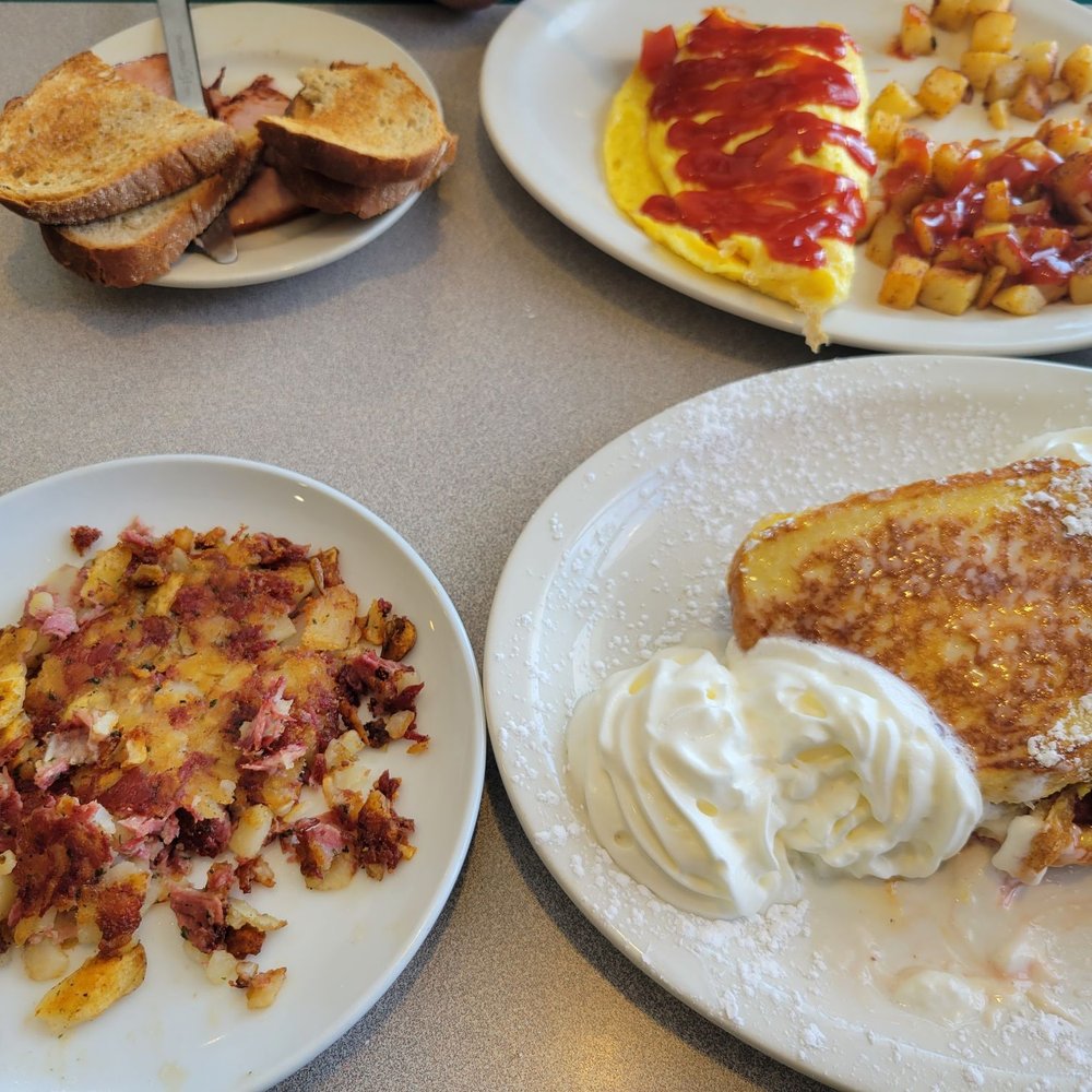 Home-made corn beef hash, stuffed French toast & an omelet with ham & Home-made rye toast.