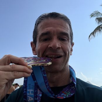 305 Half Marathon & 5k - Medal biting shot - Races & Competitions Near Me - Miami Beach, Florida