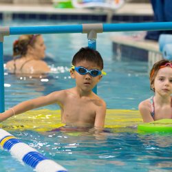 Machine Performance Center - Kids sitting on platform waiting for their turn to swim!