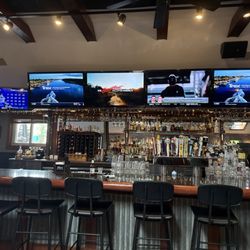 Bar area with taps, wine, and liquor.
