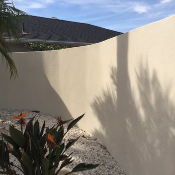 S & J Plastering - a white stucco wall with a plant in the foreground - Stucco Services Near Me - Garden Grove, California S & J Plastering - a white stucco wall with a plant in the foreground - Stucco Services Near Me - Garden Grove, California