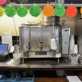 Boulevard Diner - A commercial food warmer with multiple compartments is positioned on a counter, with colorful menu tags hanging above listing various breakfast and lunch options. - Diners Near Me - Worcester, Massachusetts