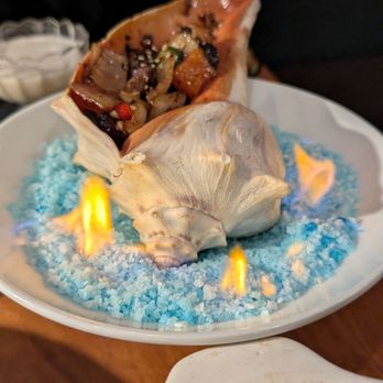 Bell86 - Grilled Conch with beef and vegetable in Conch Shell over fire - Korean Near Me - Brookline, Massachusetts