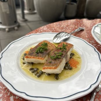 Barra Oliba - Fish meuniere served with perfectly crispy skin and delicious aromatics. - Spanish Near Me - San Diego, California Barra Oliba - Fish meuniere served with perfectly crispy skin and delicious aromatics. - Spanish Near Me - San Diego, California