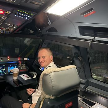 American Airlines - First Officer/Co-Pilot assisting the curious young passenger. - Airlines Near Me - Norfolk, Virginia American Airlines - First Officer/Co-Pilot assisting the curious young passenger. - Airlines Near Me - Norfolk, Virginia