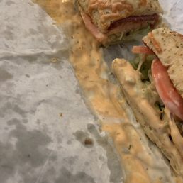 a sandwich cut in half on a piece of paper