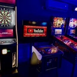 a row of pinball machines a row of pinball machines