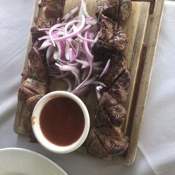 Kavkaz - Kebabs served with raw onions and tomato sauce - Armenian Near Me - North Miami Beach, Florida Kavkaz - Kebabs served with raw onions and tomato sauce - Armenian Near Me - North Miami Beach, Florida