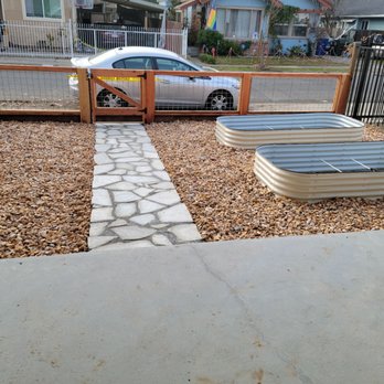 Green Landscaping - Gravel with a flagstone pathway and metal garden beds. - Landscaping Near Me Green Landscaping - Gravel with a flagstone pathway and metal garden beds. - Landscaping Near Me