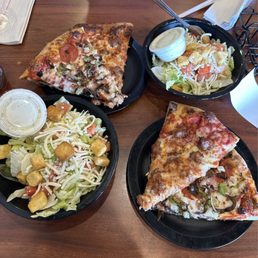 three plates of pizza and salad