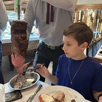 Fogo de Chão - My brother eating or just getting his meat - Brazilian Near Me - North Bethesda, Maryland