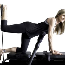 Pilates Plus OC - Tina Bungee Kicking with a smile on!