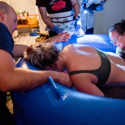 Intuitive Rhythms Midwifery & Massage - Heather passing my son to me to catch as he came out