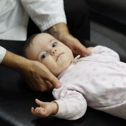 Health Centered Chiropractic - Dr. Scott Craig doing an adjustment on an infant.