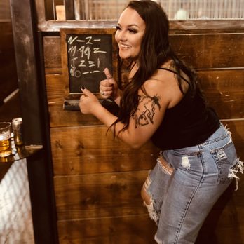 The Smart Axe Modesto - a woman leaning against a wall - Pubs Near Me - Modesto, California