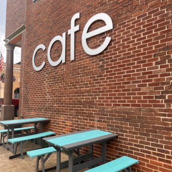 Pedal Pushers Cafe - a row of blue picnic tables in front of a brick building - American Near Me - Lanesboro, Minnesota Pedal Pushers Cafe - a row of blue picnic tables in front of a brick building - American Near Me - Lanesboro, Minnesota