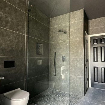 Upgraded Renovations - a bathroom with a walk in shower - General Contractors Near Me Upgraded Renovations - a bathroom with a walk in shower - General Contractors Near Me