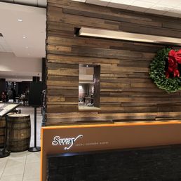 the front desk of a restaurant with a wreath on the wall the front desk of a restaurant with a wreath on the wall