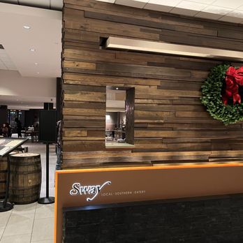 Sway - the front desk of a restaurant with a wreath on the wall - Southern Near Me - Louisville, Kentucky Sway - the front desk of a restaurant with a wreath on the wall - Southern Near Me - Louisville, Kentucky