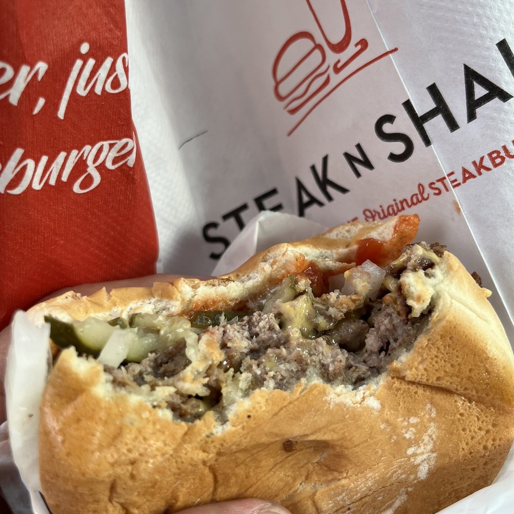 Steak ’n Shake - a hand holding a sandwich - Burgers Near Me - Coral Springs, Florida Steak ’n Shake - a hand holding a sandwich - Burgers Near Me - Coral Springs, Florida
