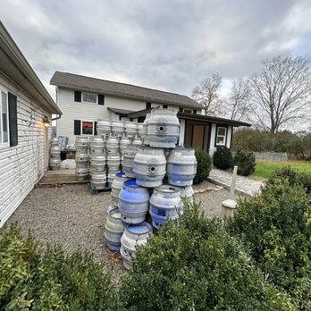 The Beerocracy - a stack of kegs in front of a house - Brewpubs Near Me - Rock Stream, New York