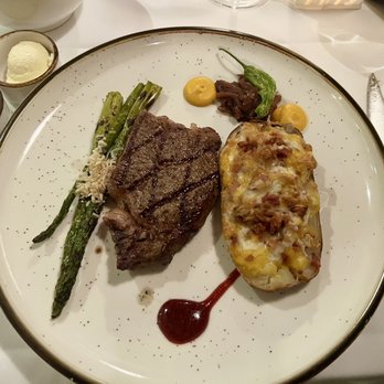 The Grove Steakhouse - Bone-In Ribeye with baked potato - Steakhouses Near Me - Alpine, California The Grove Steakhouse - Bone-In Ribeye with baked potato - Steakhouses Near Me - Alpine, California