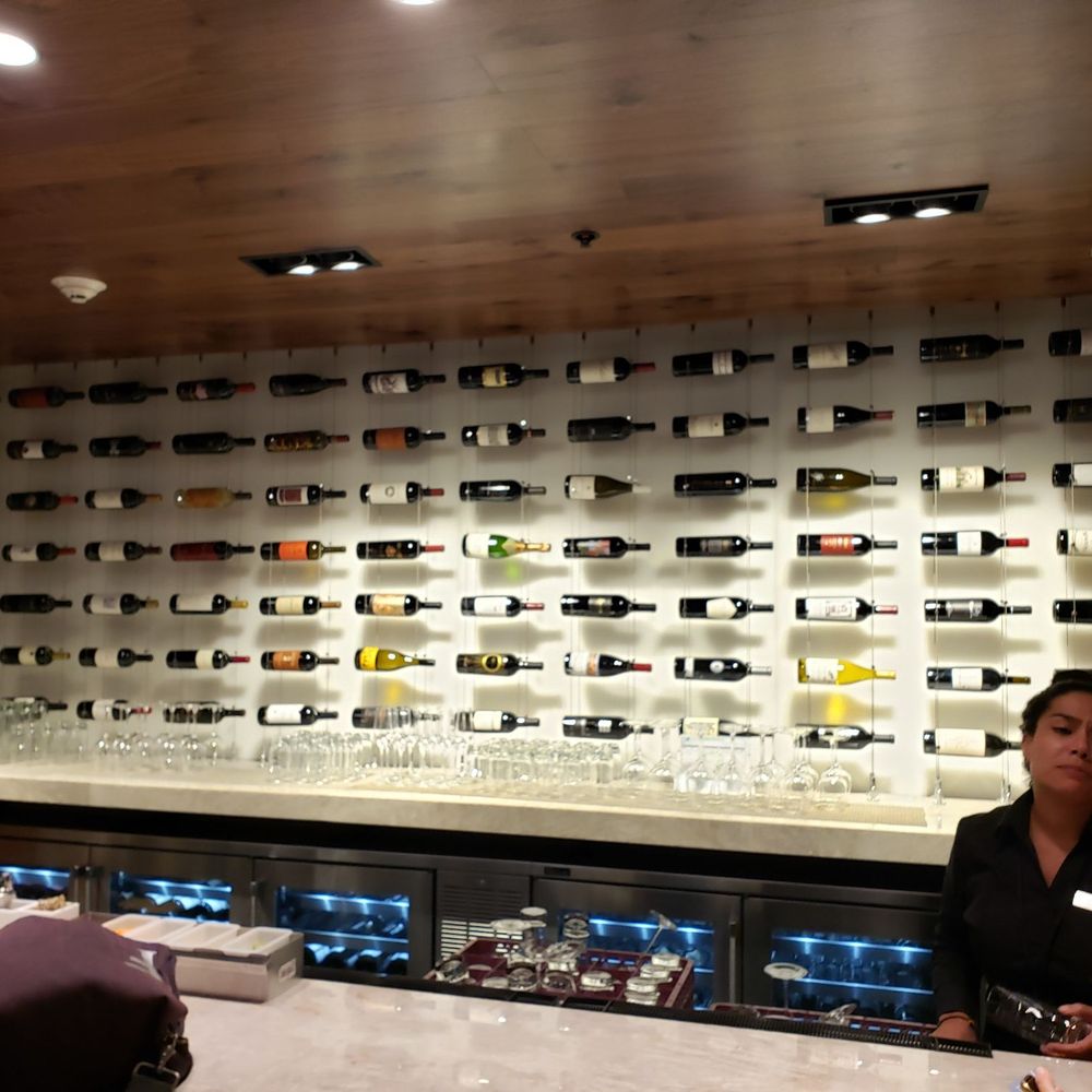 The Centurion Lounge - Back bar mainly wine versus spirits. Main bar serves cocktails ;) - Airport Lounges Near Me - Miami, Florida