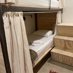 Dolores Bike Hostel - Bunk beds showing steps leading to upper bunk
