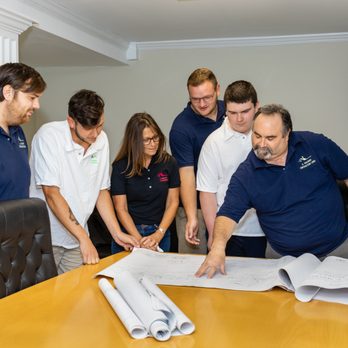 A Salerno Contracting - a group of people looking at blueprints - General Contractors Near Me - Saugerties, New York A Salerno Contracting - a group of people looking at blueprints - General Contractors Near Me - Saugerties, New York