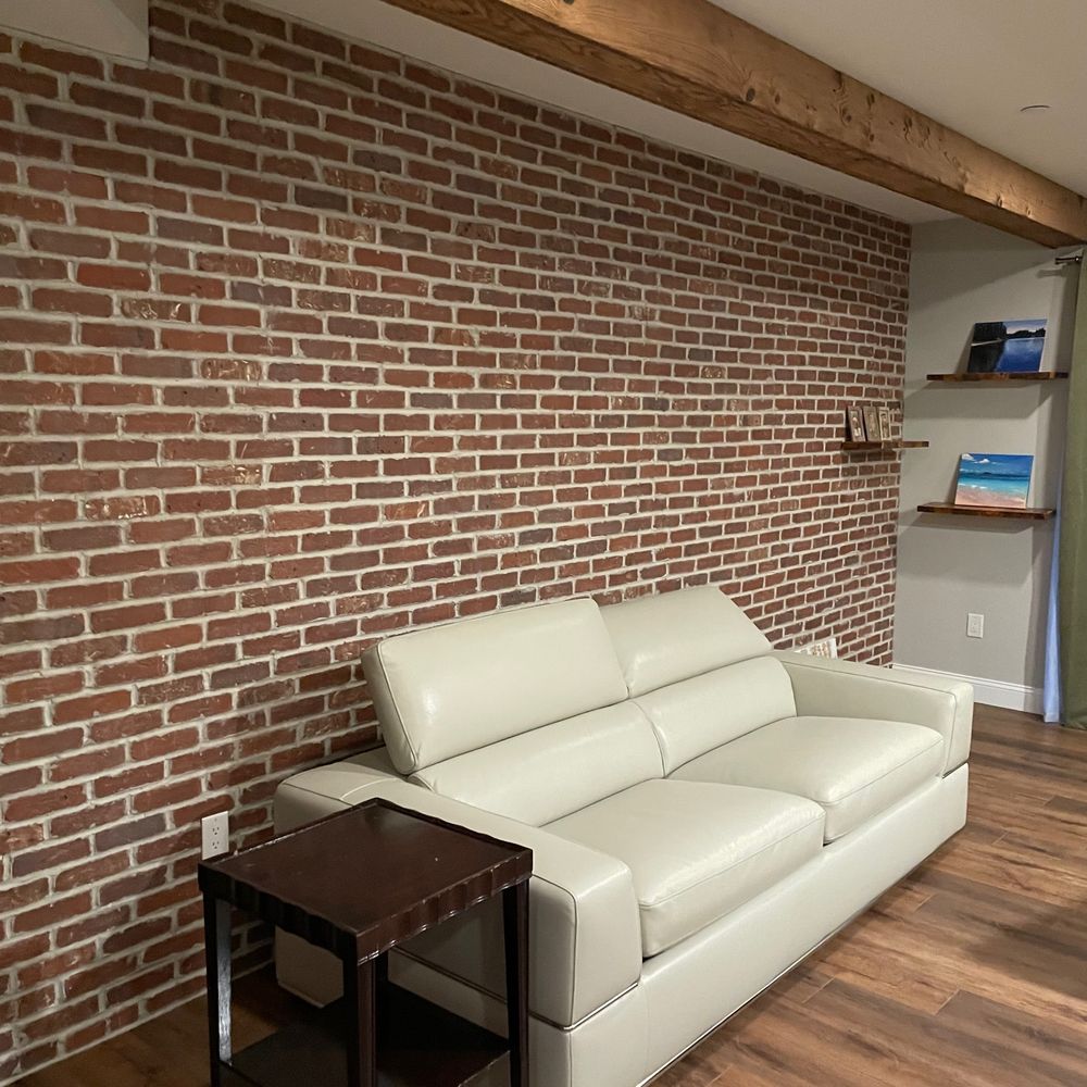 Ambler Contracting - Real brick wall with sleeper sofa - General Contractors Near Me Ambler Contracting - Real brick wall with sleeper sofa - General Contractors Near Me