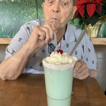 Zinburger - A wonderful Christmas milkshake (Grinch). Very minty with a white chocolate rimed glass with whipped cream and a cherry on top. - Burgers Near Me - Tucson, Arizona Zinburger - A wonderful Christmas milkshake (Grinch). Very minty with a white chocolate rimed glass with whipped cream and a cherry on top. - Burgers Near Me - Tucson, Arizona