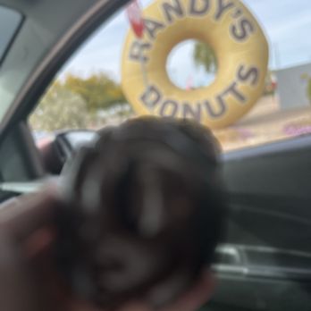 Randy's Donuts - Donut on the go! (Blurry but snapped a quick photo) - Donuts Near Me - Gilbert, Arizona