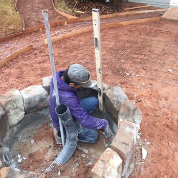 Morrison & Sons - Installing another stone Fire-pit!  The pipe will act as drainage line when completed!  Avoids standing rain water - Landscaping Near Me