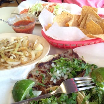 Los Burritos Tapatios - Cesina, lengua, and tripitas tacos, a side of grilled onions, steak tacos in the back. - Mexican Near Me - Downers Grove, Illinois