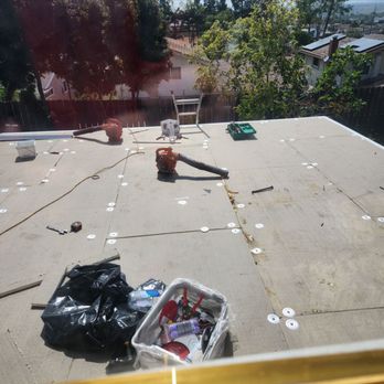 Barcenas Roofing - Laying out the 1" insulation for the TPO - Roofing Near Me