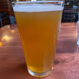 a glass of beer on a table a glass of beer on a table