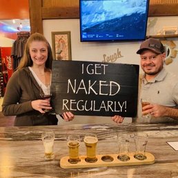a man and a woman holding up a sign