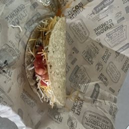 Hard shell taco with beef, lettuce, cheese and tomatoes.