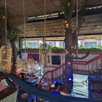 Merida Grill - Looking across the top level you see the plants in the window - Mexican Near Me - Puerto Vallarta, JAL