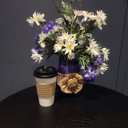 a vase of flowers and a cup of coffee a vase of flowers and a cup of coffee