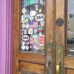 Exterior outside entrance of Sugar Bowl Cafe - They have a lot of stickers on their door. One is the US flag in all black with a single red and blue stripe. - Dorchester, Massachusetts Exterior outside entrance of Sugar Bowl Cafe - They have a lot of stickers on their door. One is the US flag in all black with a single red and blue stripe. - Dorchester, Massachusetts